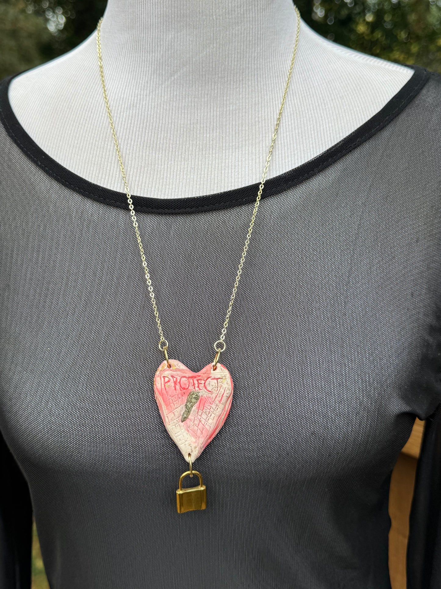 Heart-shaped necklace featuring pyrite, gold chain