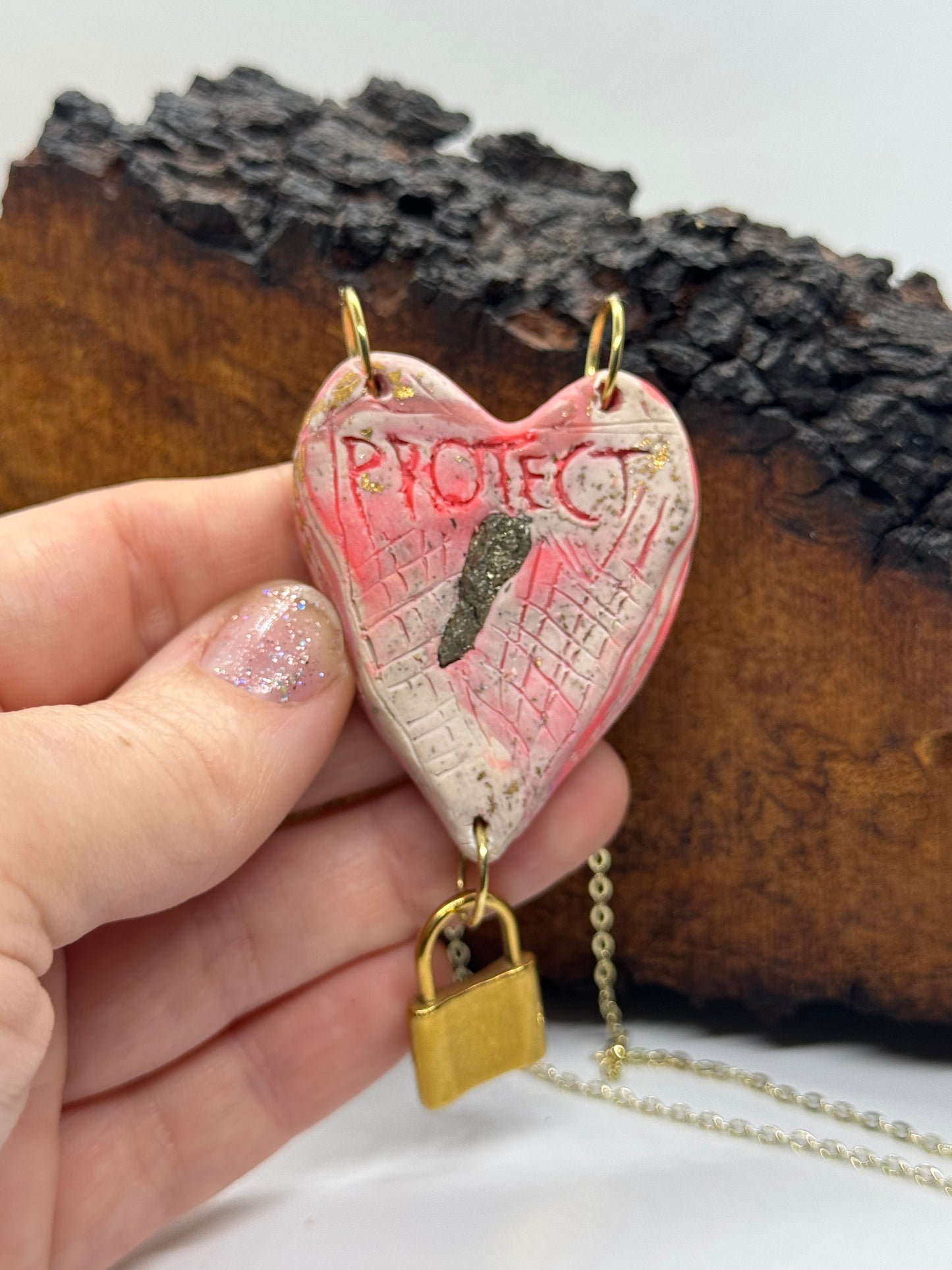 Heart-shaped necklace featuring pyrite, gold chain