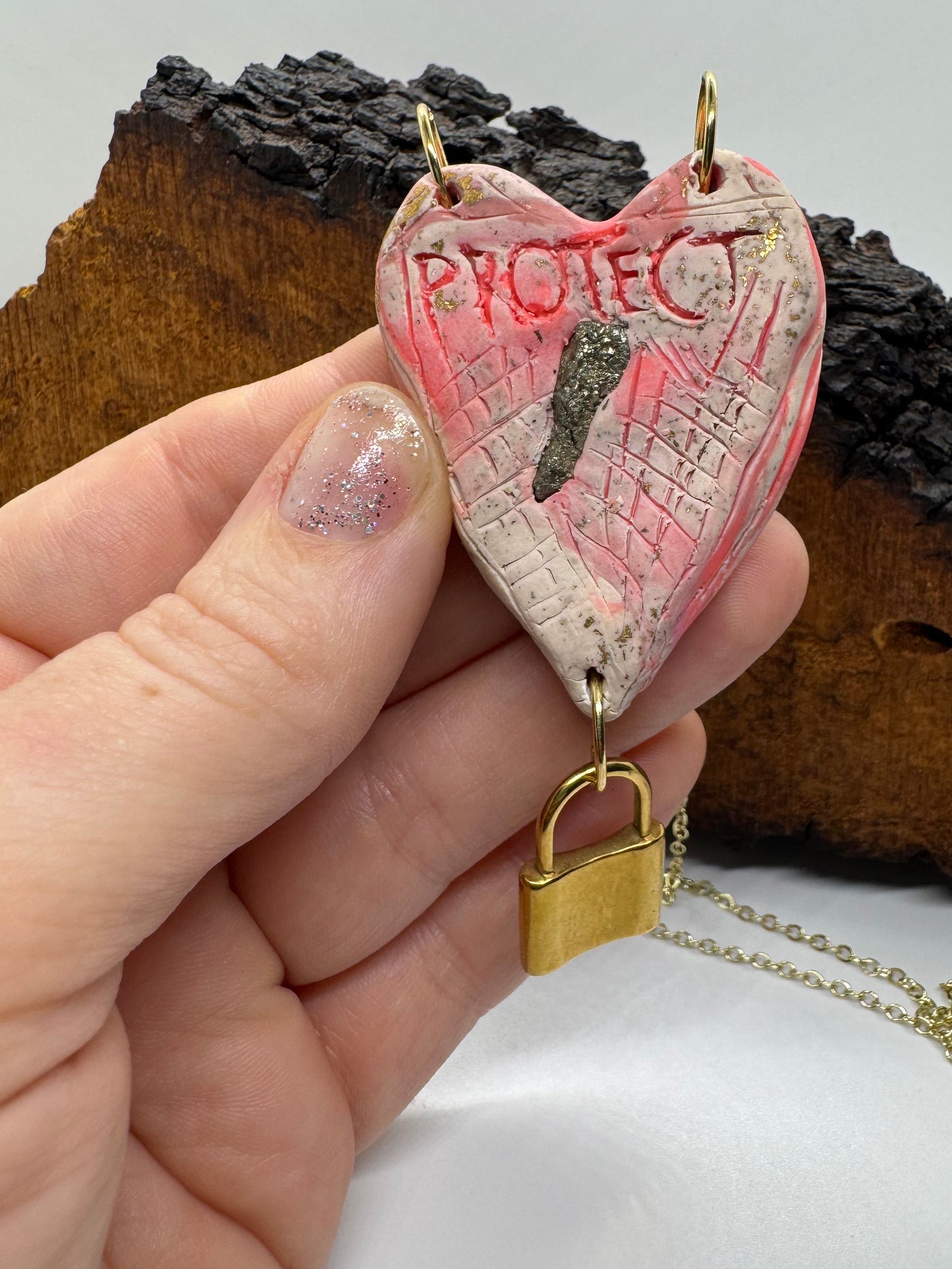 Heart-shaped necklace featuring pyrite, gold chain