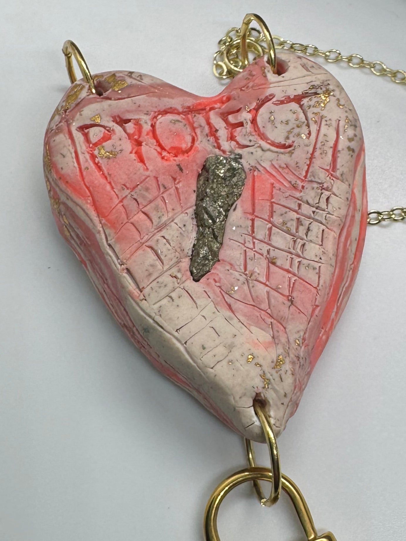 Heart-shaped necklace featuring pyrite, gold chain