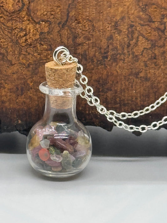 Glass bottle with rainbow tourmaline necklace