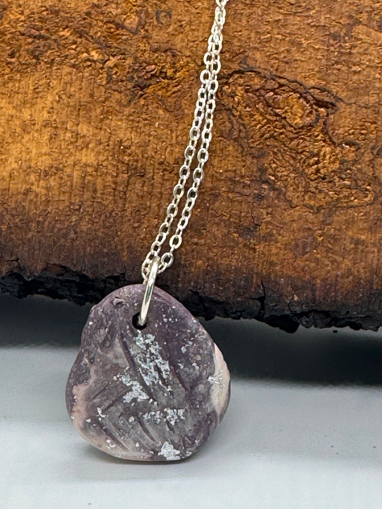 Kunzite and clay necklace on silver chain