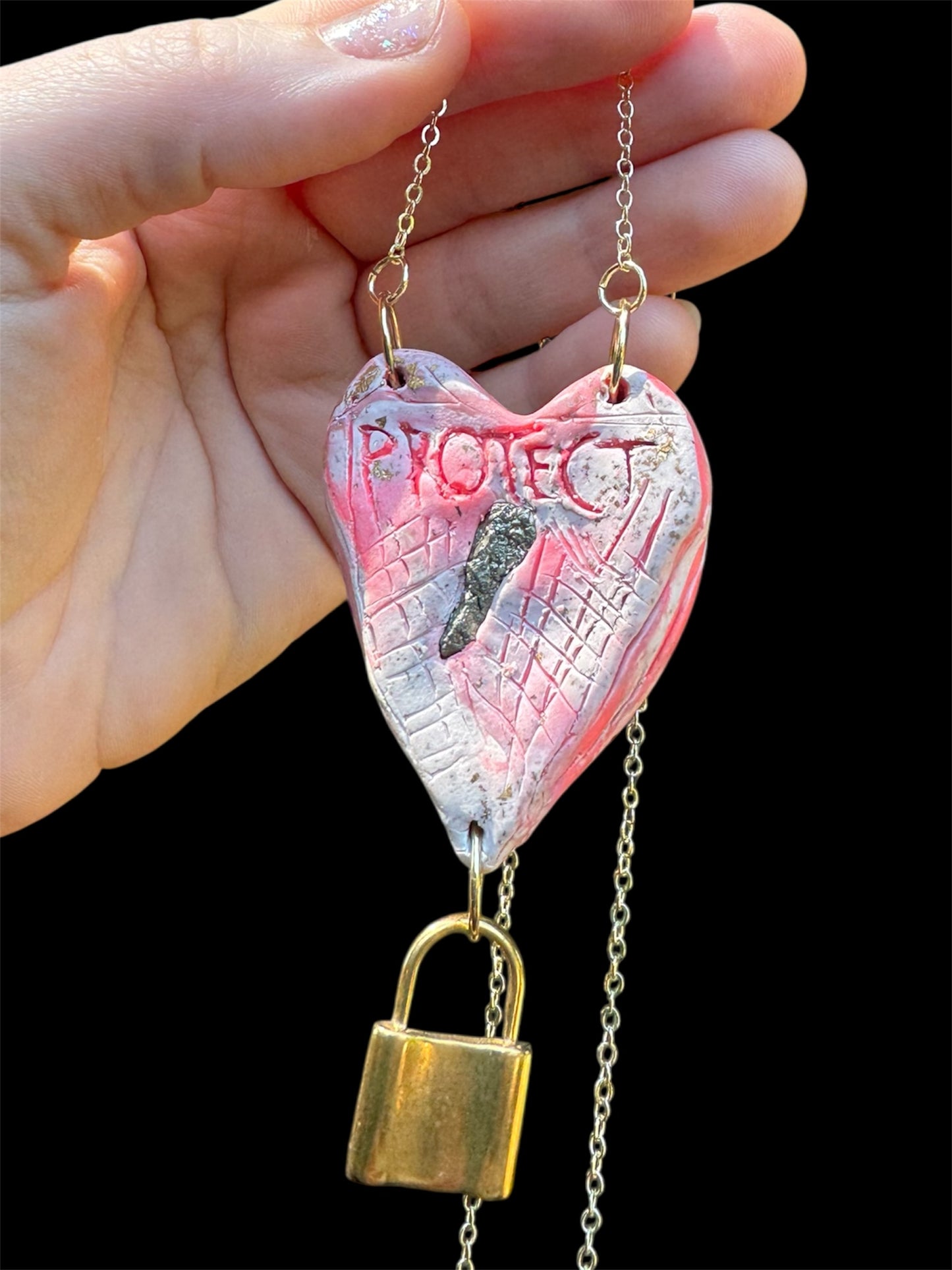Heart-shaped necklace featuring pyrite, gold chain